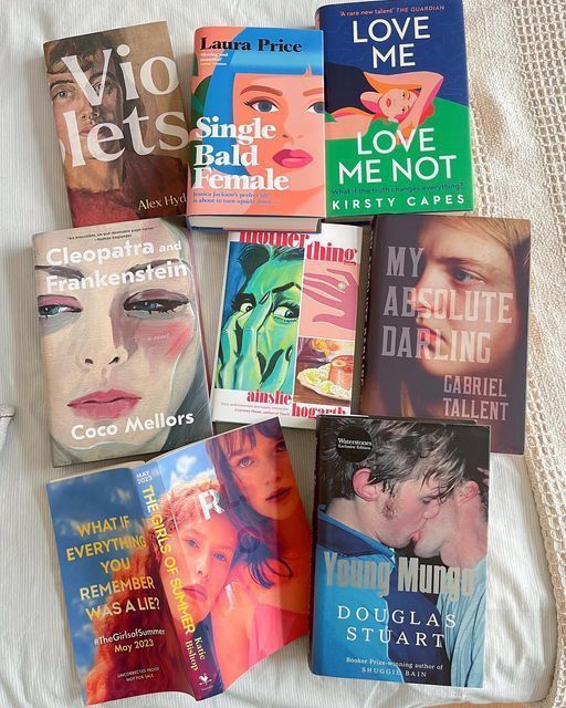 a23949e235673002f2ee0464ebb6a679 Books Splayed out showcasing colorful covers.